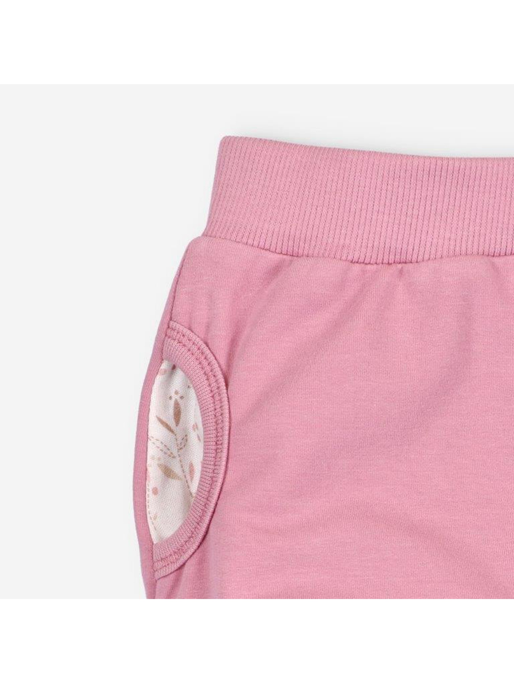 Spodnie niemowlęce z bawełny organicznej dla dziewczynki różowe