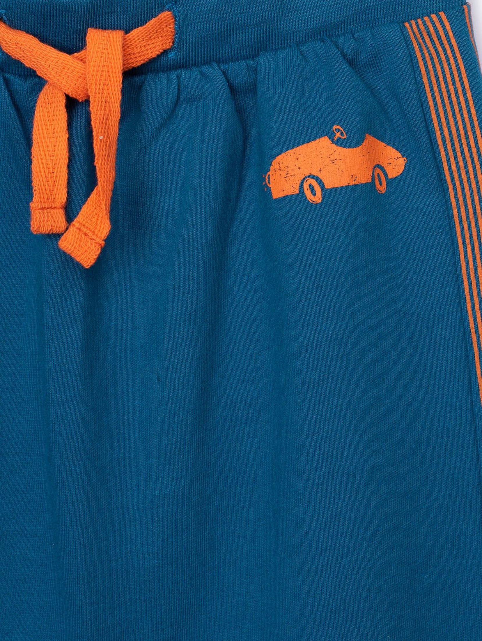 Niebieskie spodnie dresowe niemowlęce z pomarańczowymi wstawkami