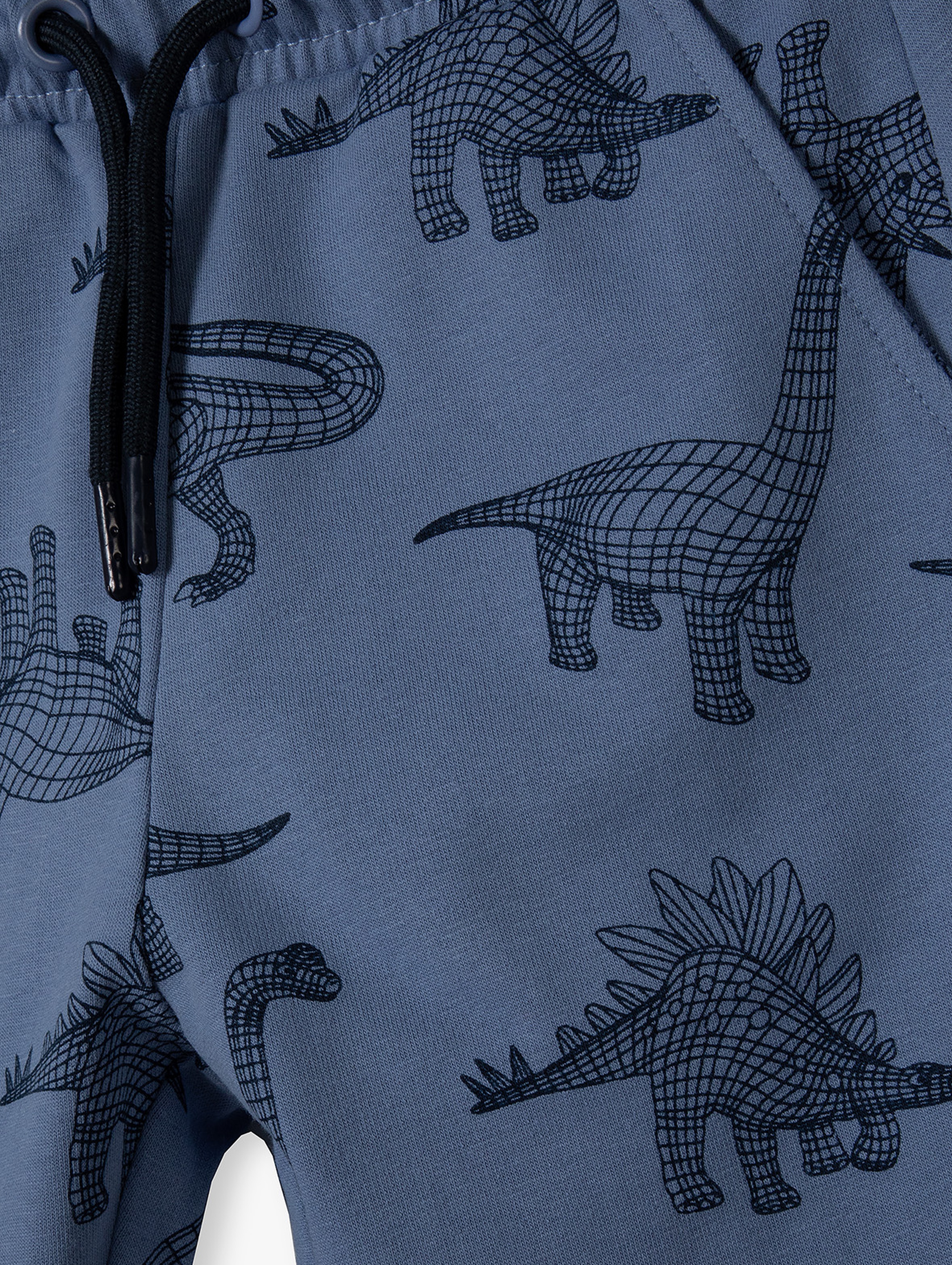 Niebieskie spodnie dresowe bawełniane regular - Dinozaury