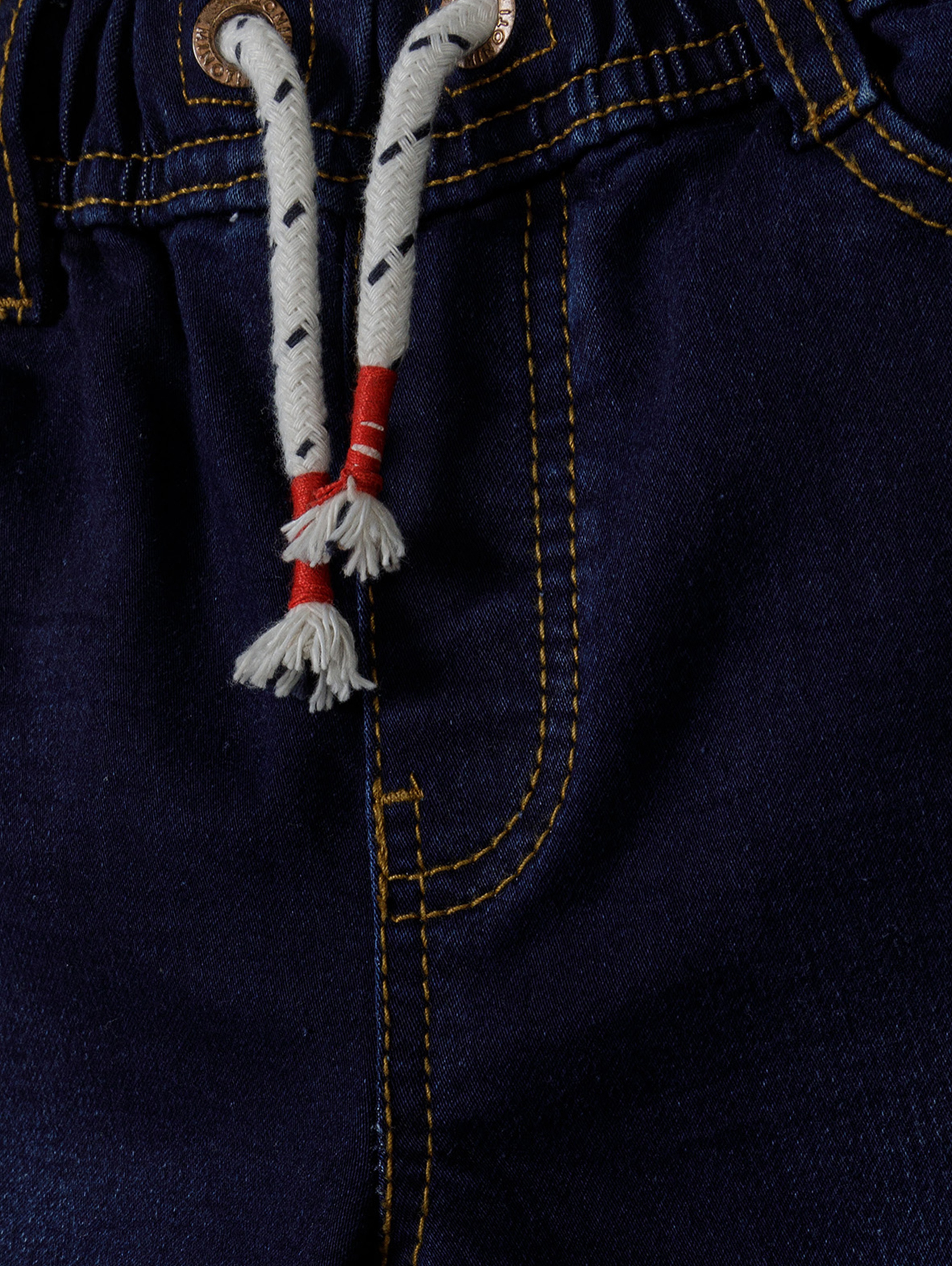 Ciemne jeansy ze ściągaczem oraz kieszeniami niemowlęce