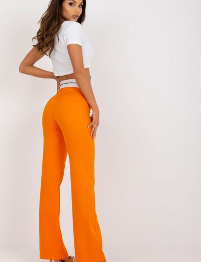 Pomarańczowe eleganckie spodnie dzwony