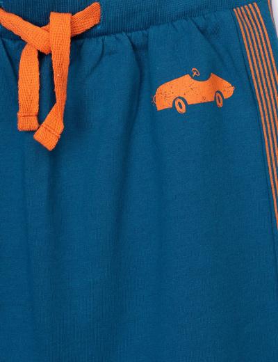Niebieskie spodnie dresowe niemowlęce z pomarańczowymi wstawkami