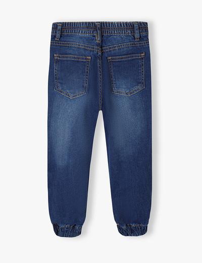 Ciemne spodnie jeansowe typu joggery dziewczęce