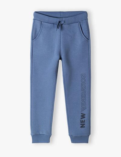 Spodnie dresowe niebieskie z napisem na nogawce- New generation