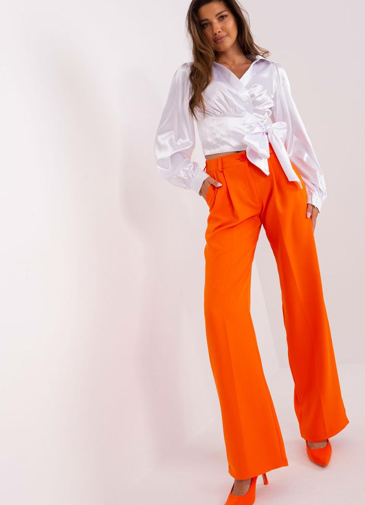 Pomarańczowe garniturowe spodnie z kieszeniami